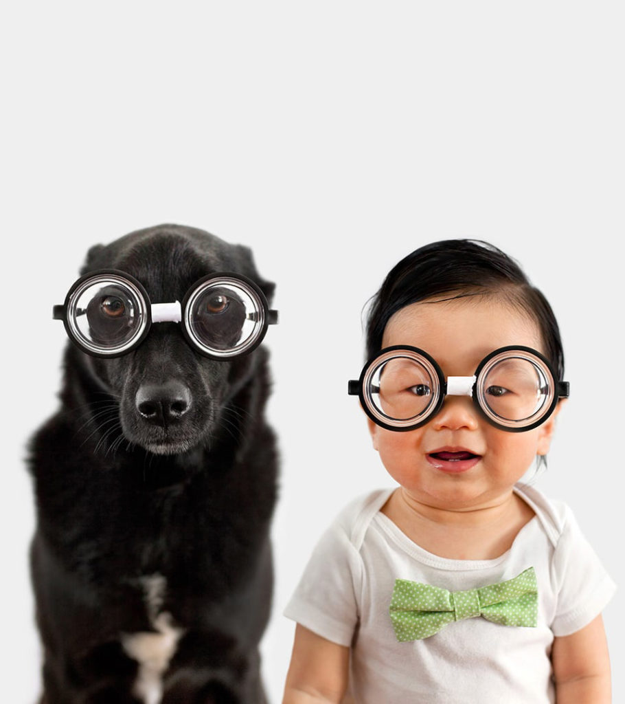 Grace Chon's pet photography series "Zoey & Jasper". This cute pet portrait shows the dog and baby wearing matching coke bottle glasses.
